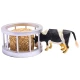 Round hayrack with hay bale and cow